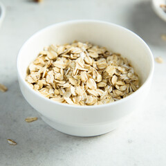 Healthy rolled oats in a white bowl