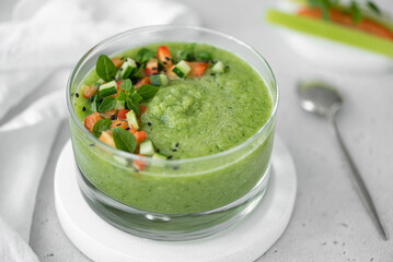 chilled cucumber gazpacho with herbs and spices in a glass bowl