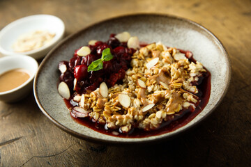 Healthy oatmeal porridge with cherries and almond