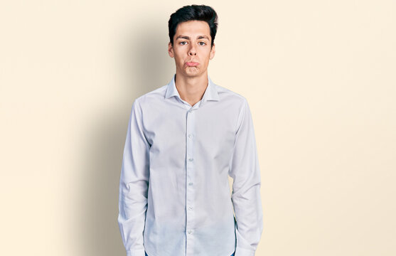 Young hispanic business man wearing business clothes depressed and worry for distress, crying angry and afraid. sad expression.