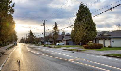 Fototapeta na wymiar Fraser Heights, Surrey, Greater Vancouver, BC, Canada. Street view in the Residential Neighborhood during a colorful spring season. Colorful Sunrise Sky.