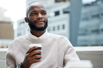Fuelled and ready to keep at his goals. Shot of a young businessman looking thoughtful while...