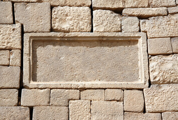 Ancient wall of stone blocks of different sizes and frame with copy space for text