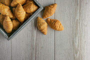 Croissants for tasty breakfast. Original tasty French croissants with cheese and on the wooden table.