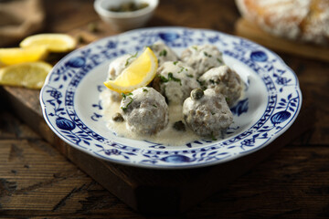 Traditional homemade meatballs with cream, capers and lemon