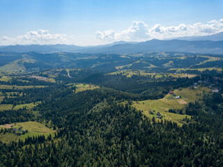 Green mountains of Ukrainian Carpathians in summer. Sunny day. Aerial drone view.