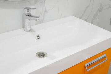 Modern white bathroom sink with faucet