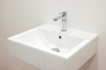 Modern white bathroom sink with faucet
