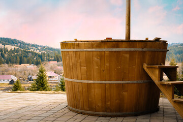 Rustic hot tub against mountain landscape