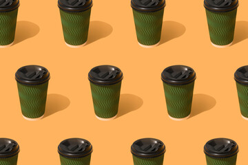 Pattern with green eco paper coffee cup on orange background, mockup. Sustainable food packaging concept