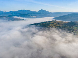 Morning mist in Ukrainian Carpathian mountains. Aerial drone view.