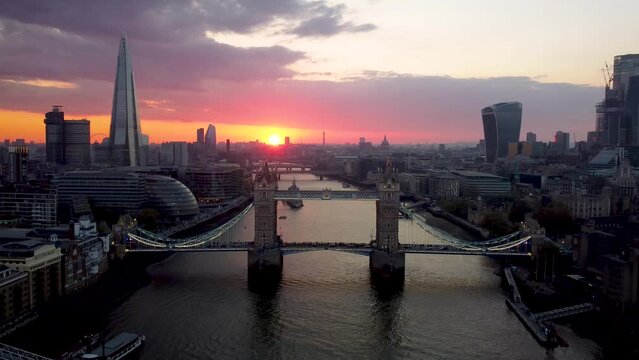 Aerial sunset view of the Tower Bridge of London with city skyline and river Thames, England