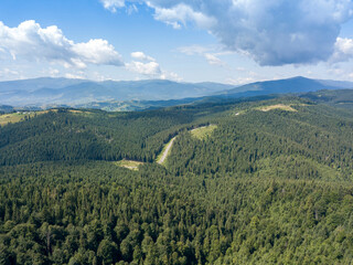 Obraz premium Green mountains of Ukrainian Carpathians in summer. Sunny day. Aerial drone view.