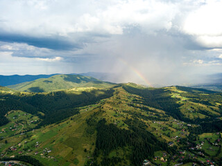 Rainbow in the mountains of the Ukrainian Carpathians. Aerial drone view.