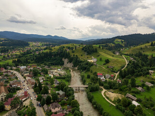 Settlement in the mountains of the Ukrainian Carpathians. Aerial drone view.