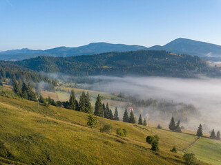 Morning mist in Ukrainian Carpathian mountains. Aerial drone view.