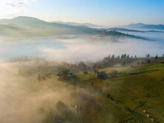 Green mountains of the Ukrainian Carpathians in the morning mist. Aerial drone view.