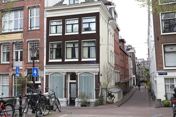 Fototapeta na wymiar Amsterdam Bloemgracht Canal Street View with Traditional House Facades and Parked Bicycles, Netherlands