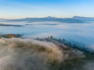 Morning mist in Ukrainian Carpathian mountains. Aerial drone view.