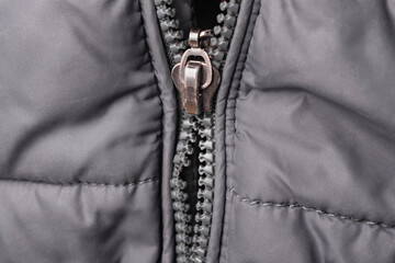 Close-up of a broken zipper on a jacket.