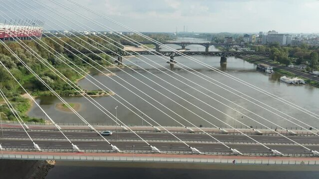 Aerial drone view of Świętokrzyski Bridge, vistula river and PGR Narodowy - National stadium in the background. Warsaw, Poland.