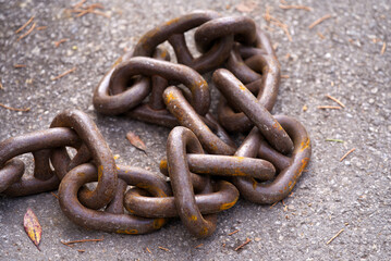 Close-up of rusty anchor chain at border of Lake Geneva at City of Montreux on a cloudy spring day....