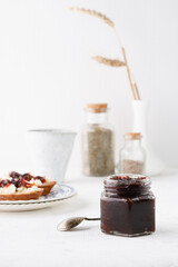 onion marmalade (Onion confiture). onion confit in a glass jar on a white background.