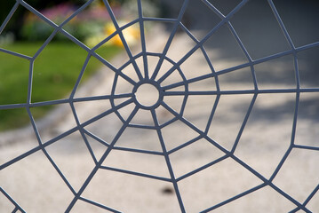 Iron gate at in shape of a spider web at villa of City of Montreux, Canton Vaud, on a cloudy spring day. Photo taken April 4th, 2022, Montreux, Switzerland.