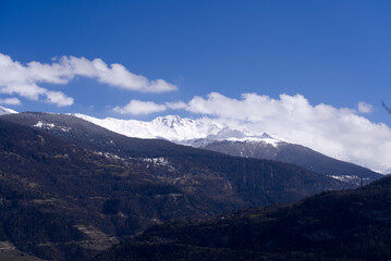 Aerial view from hill of City of Sion over the beautiful landscape of Canton Valais with the Swiss Alps on a blue cloudy spring day. Photo taken April 4th, 2022, Sion, Switzerland.