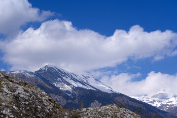 Aerial view from hill of City of Sion over the beautiful landscape of Canton Valais with the Swiss Alps on a blue cloudy spring day. Photo taken April 4th, 2022, Sion, Switzerland.