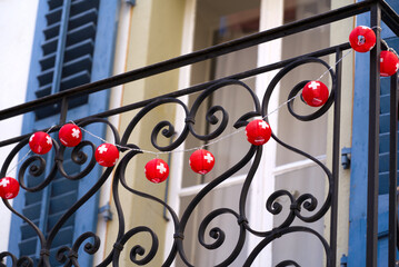 Decoration with red lampions with white Swiss cross hanging form wrought iron railing at the old...