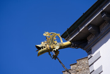 Golden dragon decoration of spout at the old town of Sion, Canton Valais, on a sunny spring day. Photo taken April 4th, 2022, Sion, Switzerland.