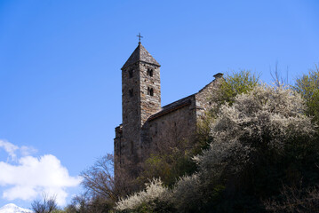 Fototapeta na wymiar Beautiful medieval catholic chapel at castle Basilique de Valère (Valeria) on a hill at City of Sion on a sunny spring day. Photo taken April 4th, 2022, Sion, Switzerland.