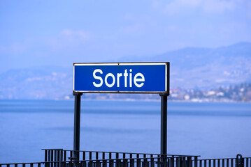 Sign with text Sortie (French, translation is Exit) at border of Lake Geneva at City of Montreux on...