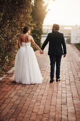 May be always walk through life together. Rearview shot of a couple walking together on their wedding day.