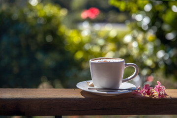 Coffee espresso on wood table nature background in garden, warm tone. morning coffee