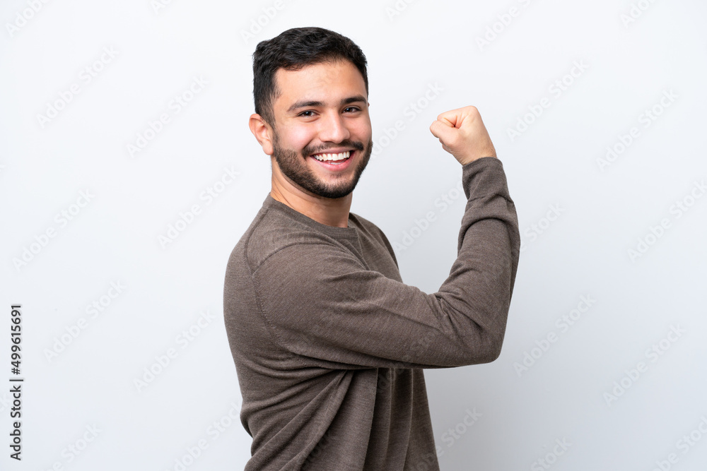 Wall mural Young Brazilian man isolated on white background doing strong gesture