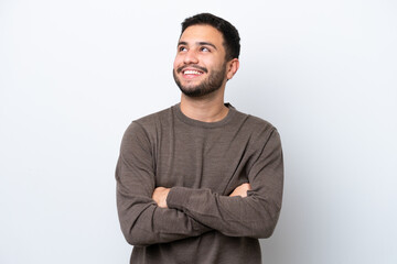 Young Brazilian man isolated on white background looking up while smiling