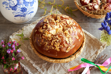 Mazanec, traditional Czech sweet Easter pastry, with spring flowers and pomlazka