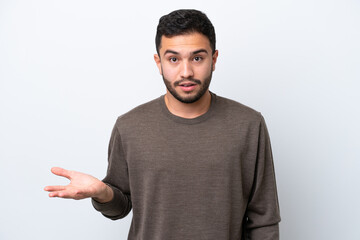 Fototapeta premium Young Brazilian man isolated on white background making doubts gesture