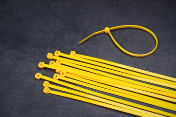 Yellow cable tie on the cement floor background