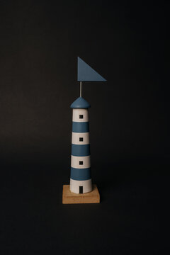 isolated blue lighthouse miniature on black background. High quality photo