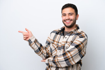 Fototapeta premium Young Brazilian man isolated on white background pointing finger to the side
