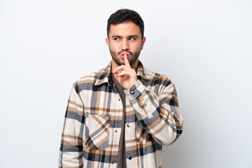 Young Brazilian man isolated on white background showing a sign of silence gesture putting finger in mouth