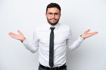 Business Brazilian man isolated on white background having doubts while raising hands