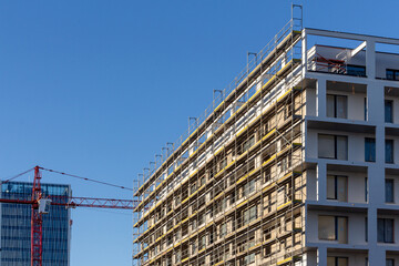 Modern building is under construction, metal scaffolding