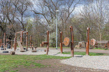 Outdoor gym fitness in a public park wooden sports equipment early spring