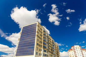 Solar panels installed on the outer wall of residential building.