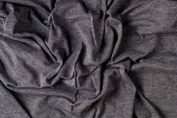 Dark grey crumpled fabric background for your design. Knitwear cotton abstract texture