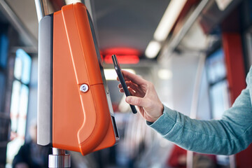Man buying ticket via digital wallet. Contactless paying for public transportation with mobile...